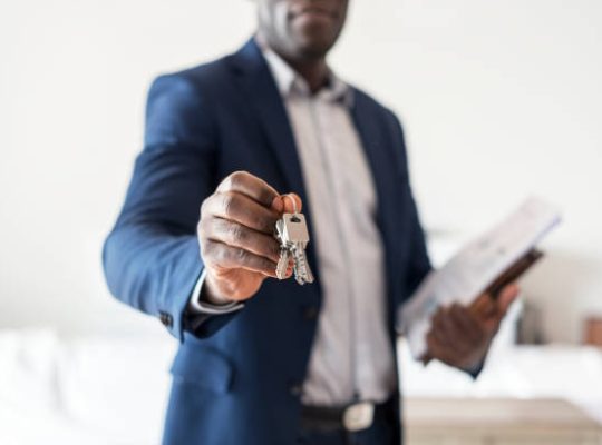 Real estate agent handing the house key