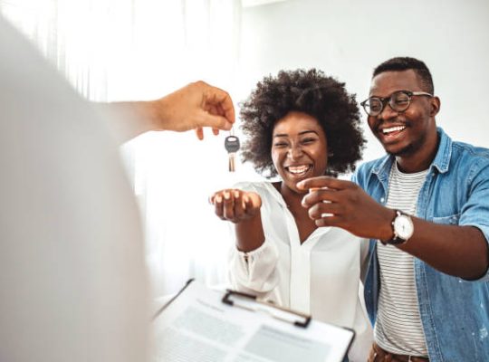 Young couple in love starting family life, got a chance of acquiring independent home ownership, given key from new apartment, social renting, purchasing new apartment, meeting with real estate agent